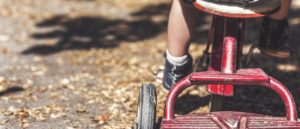 Rear image of child on tricycle