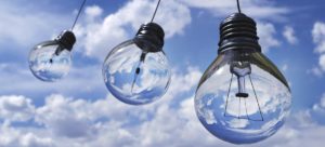Light bulbs floating in sky