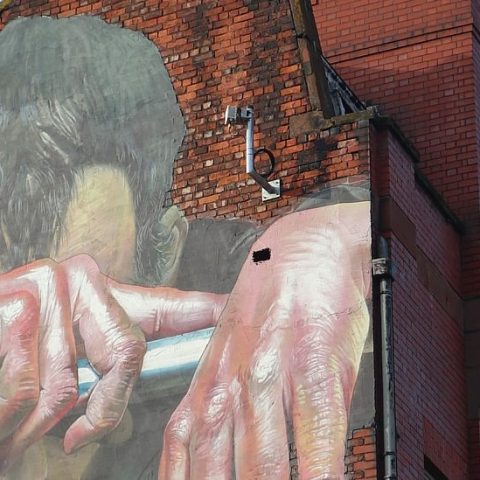 Sad man painting on building - Photo by Simon Watkinson on Unsplash