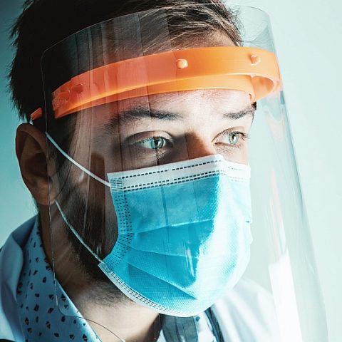 Photo of healthcare professional in personal protective equipment.