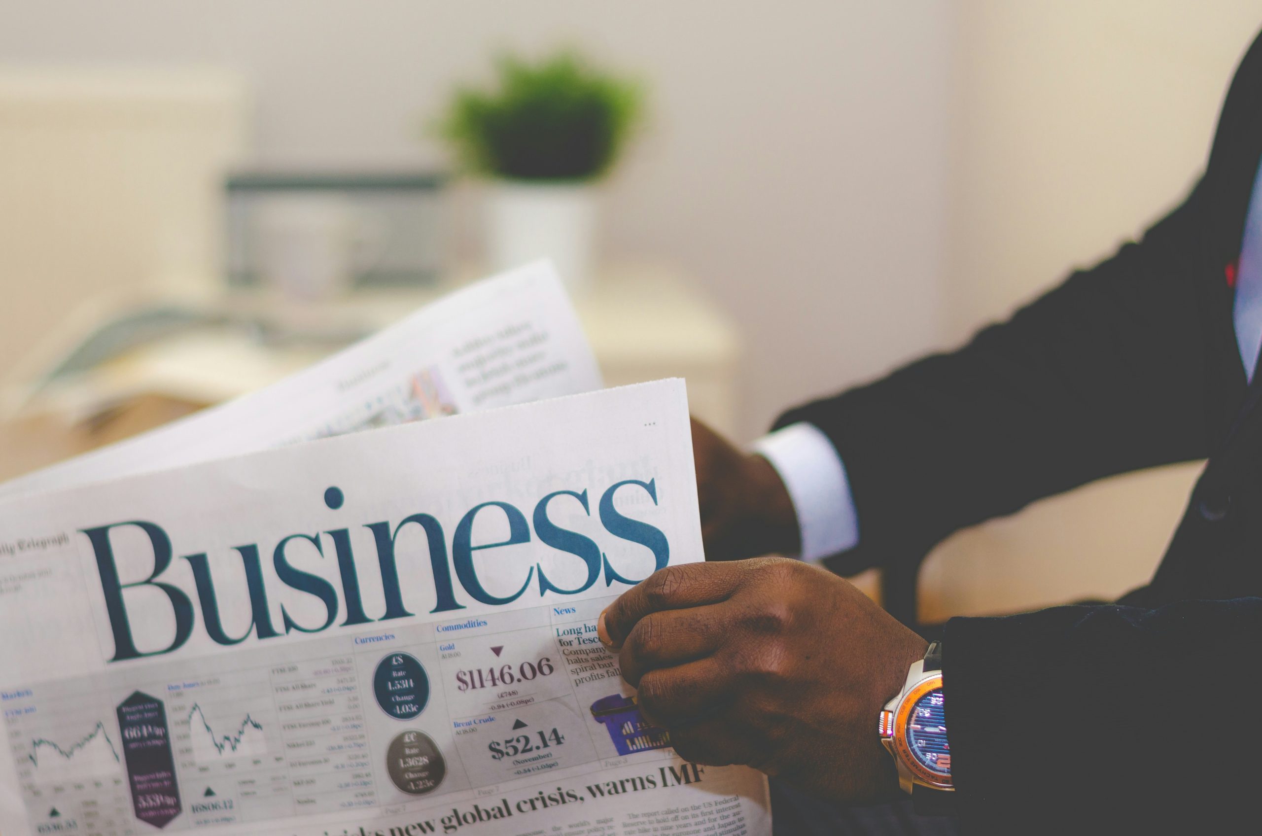 image of person reading business section of newspaper representing the importance of appropriate business ownership structures