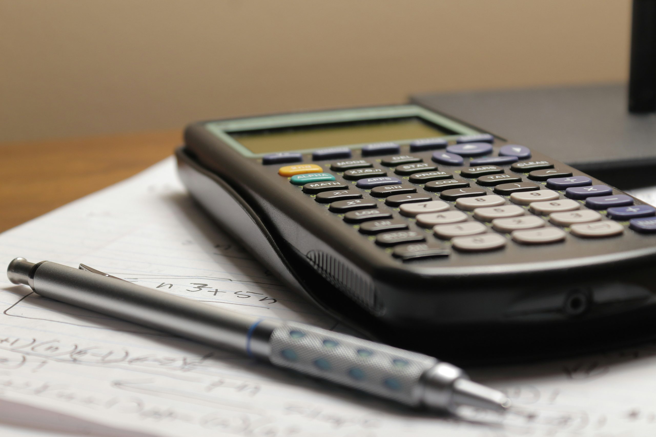 calculator and notebook illustrating Self-managed super funds and their benefits