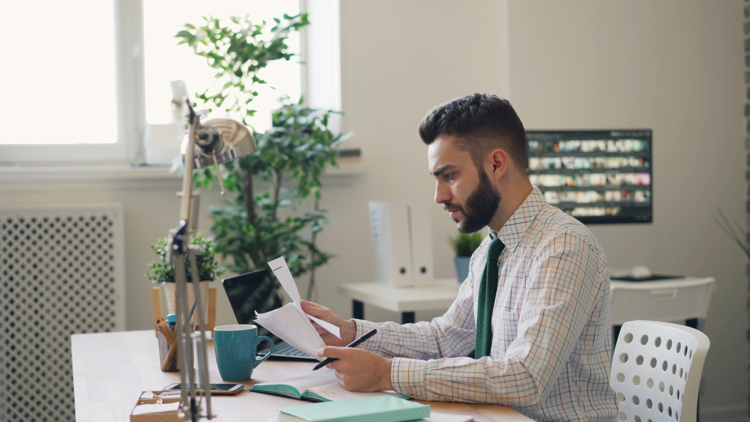 image of man sitting at desk contemplating an employment contract