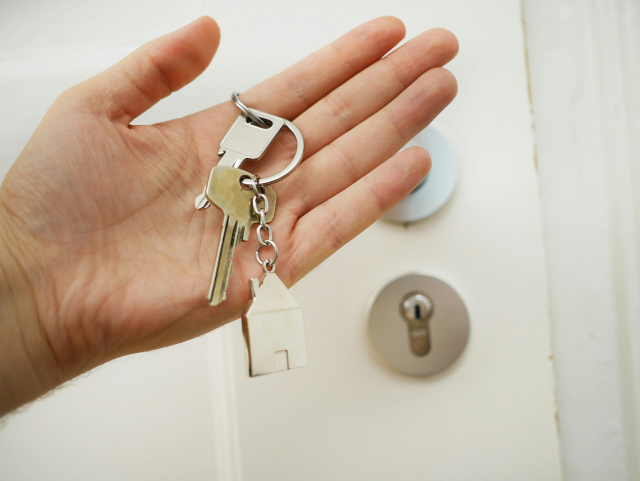 A person holding keys to their house, having just visited a family lawyer in Canberra.