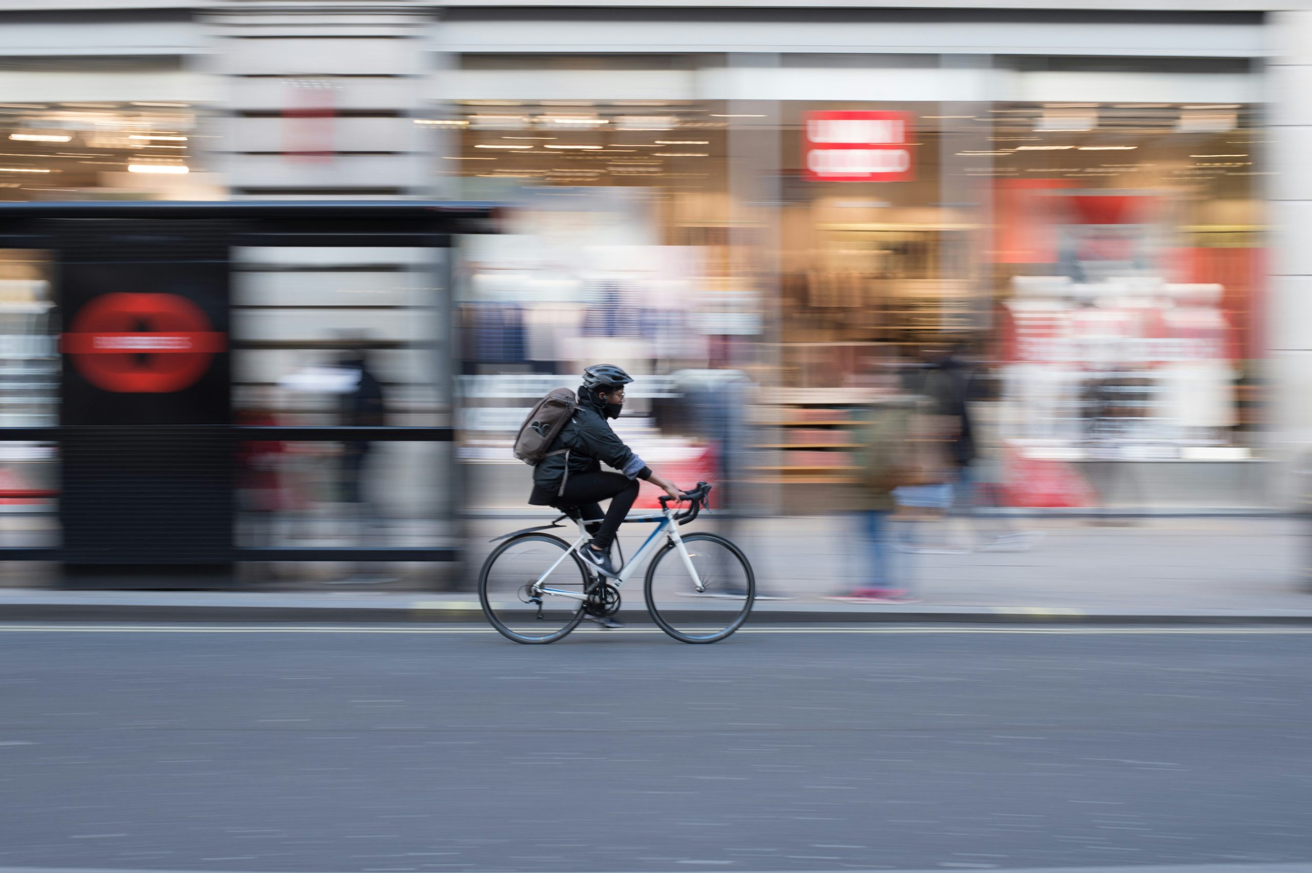 image of person on pushbike riding through the city