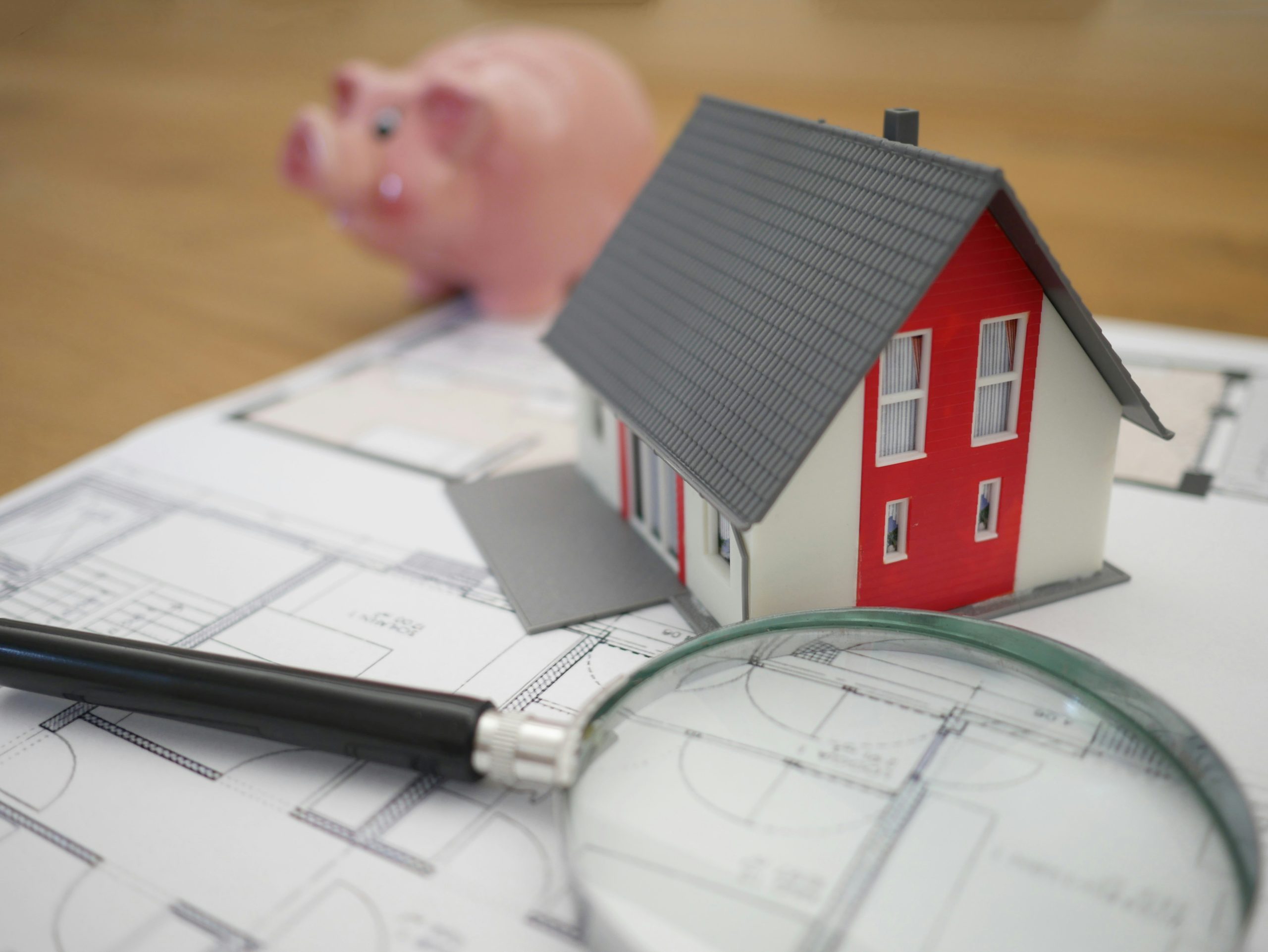 Image of house plans and piggy bank representing self managed superannuation schemes and their borrowing capacity